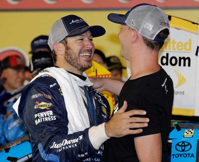 Martin Truex Jr., left, celebrates with his crew chief Cole Pearn in Victory Lane after winning the NASCAR Sprint Cup Series race at Darlington Raceway on Sunday in Darlington, S.C.