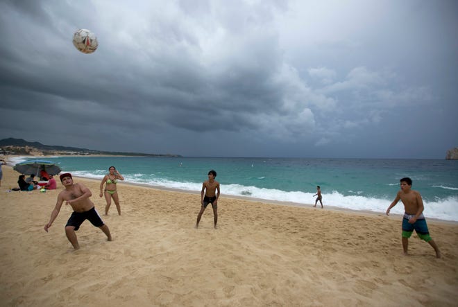 People play on El Medano Beach before the arrival of Hurricane Newton in Cabo San Lucas, Mexico, Monday Sept. 5, 2016. Authorities at the southern end of Mexico's Baja California peninsula ordered schools closed and set up emergency shelters as Hurricane Newton gained strength while bearing down on the twin resorts of Los Cabos for a predicted arrival Tuesday morning. (AP Photo/Eduardo Verdugo)