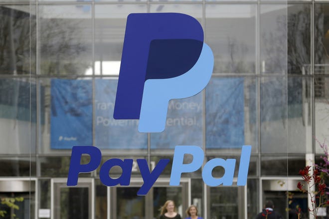This March 2015, file photo, shows signage outside PayPal headquarters in San Jose, Calif. After a tax ruling against Apple on Tuesday the spotlight turns to dozens of companies that have boosted earnings taking advantage of low tax rates abroad. One such company who benefitted in 2015 was PayPal Holdings. (AP Photo/Jeff Chiu, File)