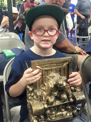 Dylan Berio, 8, with his "crowd favorite" trophy Mass Blast Powerlifting Competition. Submitted