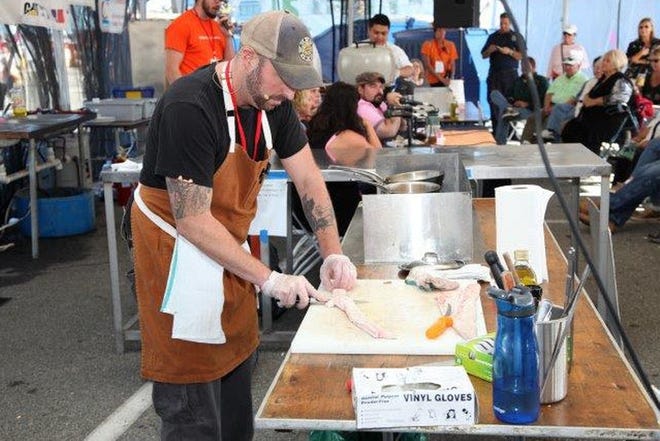Chef Chris Cronin preps a fillet for cooking. He and Chef Henry Bousquet will compete to create a winning seafood dish using a secret seafood ingredient and local produce from the farmers market. CONTRIBUTED PHOTO