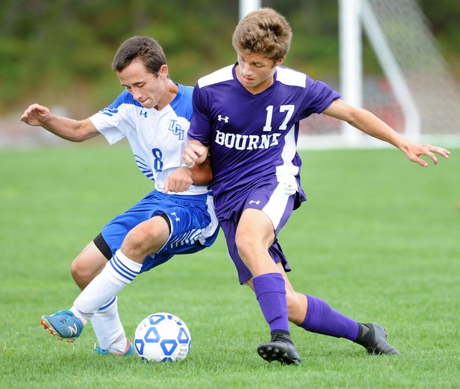 Christian Turner, right, of Bourne battles for the ball with Ben Cardoso of Upper Cape Tech in Wednesday's game. Ron Schloerb/Cape Cod Times