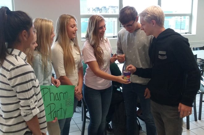Flagler Palm Coast High School students use the Bean Boozeled game to illustrate the risks of "pharm parties." from left are Francine Hoang, Peyton Halliday, Shelby Beck, Ekatereena Koucina, Samantha Picano, Hayden Hawkins and Dylan Germano. NEWS-JOURNAL/SHAUN RYAN