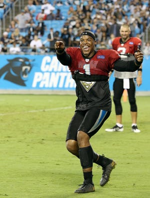 Carolina Panthers' quarterback Cam Newton gets the fans fired up near the end of their practice at Fan Fest Aug. 5 at Bank of America Stadium. JOHN CLARK/THE GAZETTE