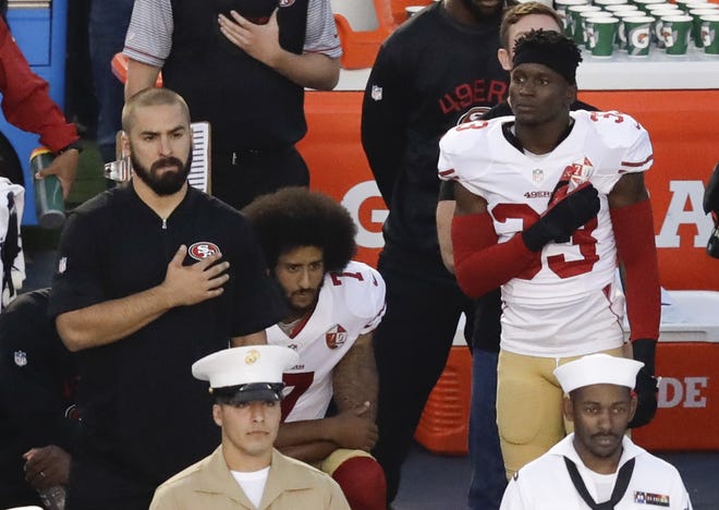 NFL Commissioner Roger Goodell disagrees with 49ers quarterback Colin Kaepernick's, middle, choice to kneel during the national anthem, but recognizes the quarterback's right to protest. The Associated Press