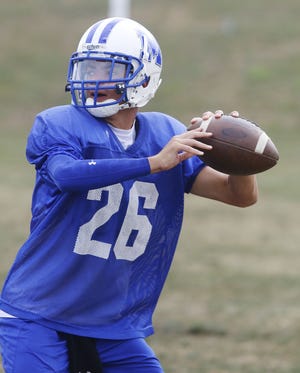 Junior quarterback Tyrese O’loughlin of Middletown looks to pass during a practice last month. The Islanders are now in Division II after winning three of the past six D-III championships.