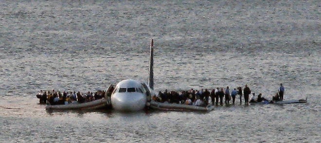 In this Thursday Jan. 15, 2009 file photo, airline passengers wait to be rescued on the wings of a US Airways Airbus 320 jetliner that safely ditched in the frigid waters of the Hudson River in New York, after a flock of birds knocked out both its engines. The audio recordings of US Airways Flight 1549, released Thursday, Feb 5, 2009 by the Federal Aviation Administration, reflect the initial tension between tower controllers and the cockpit and then confusion about whether the passenger jet went into the river. (AP Photo/Steven Day) ** EDITORS NOTE RESTRICTIONS: TO USE THIS IMAGE IN AN EDITORIAL MAGAZINE, PLEASE CONTACT YOUR AP IMAGES LICENSING REPRESENTATIVE. SPECIAL RATES APPLY **
