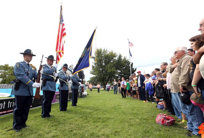 The Kansas Highway Patrol Honor Guard present the colors as the Sweet Adelines group prepares to sing the National Anthem during the opening ceremony for the Kansas State Fair in Gottschalk Park at the Kansas State Fair, Friday, Sept. 9, 2016.