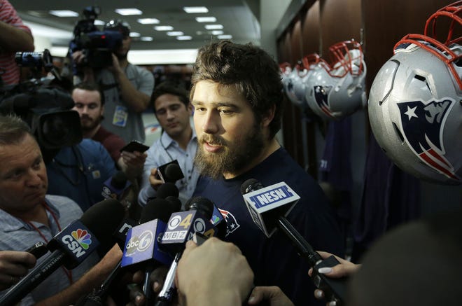 Patriots center David Andrews takes questions from reporters in the locker room before Wednesday's practice in Foxboro.