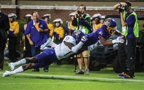Eastern Carolina’s Zay Jones dives into the end zone tailed by Western Carolina’s Tra Hardy during an NCAA college football game in Greenville last week Saturday.