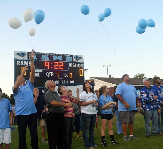 Family and friends release balloons in memory of 16-year-old Northside junior Tyler Bigham who died from injuries suffered in a single-vehicle accident on Aug. 22. The memorial was before the start Northside High School's football game against Bibb County High School on Friday in Northport. Photo | Jason Harless