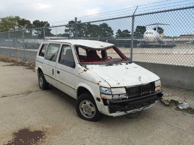 ADVANCE FOR USE SUNDAY, SEPT. 11, 2016 AND THEREAFTER-This Aug. 18, 2016 photo provided by the Port Authority shows a van damaged in the Sept. 11, 2001 terrorist attacks on the World Trade Center, outside Hangar 17 at the JFK airport in New York. When the Port Authority shuttered the artifact program in August, officials moved the only remaining artifact to the tarmac. (Amy Passiak/Port Authority of New York and New Jersey via AP)