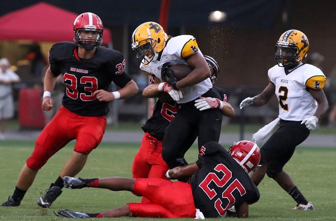 Lincolnton #8 Xavier McClain is tackled by South Point #21 Tenner Canterberry and #25 Mario Brandon Jr. in the first half of their game Friday night, Aug. 26 at South Point High School in Belmont. FILE PHOTO MIKE HENSDILL/THE GAZETTE
