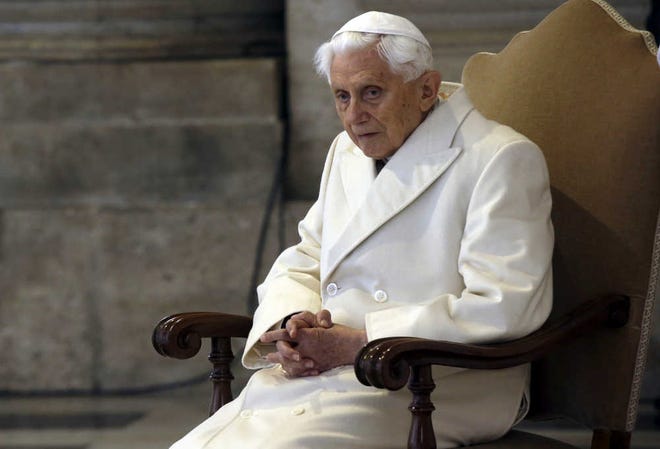 FILE - This Dec. 8, 2015 file photo shows Pope Emeritus Benedict XVI sitting in St. Peter's Basilica as he attends the ceremony marking the start of the Holy Year, at the Vatican. Excerpts of a new book-interview, "The Last Conversations" by Benedict and German journalist Peter Seewald were published Thursday, Sept. 8, 2016 in Italy's Corriere della Sera where the retired pope offers final reflections on papacy. (AP Photo/Gregorio Borgia)