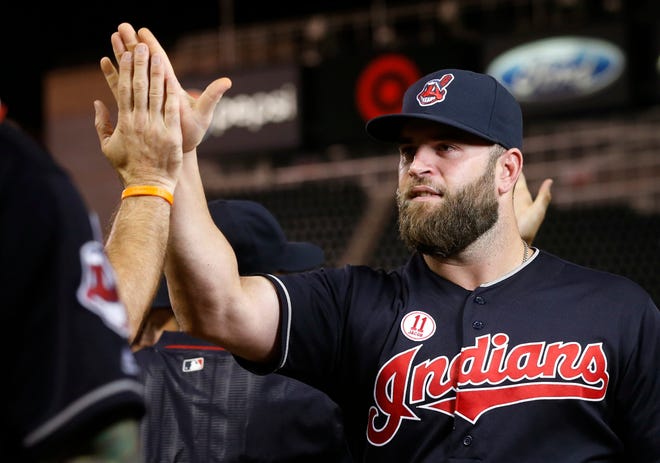 Cleveland Indians' Mike Napoli gets a high-five after the Indians defeated the Minnesota Twins 5-4 in a baseball game Friday, Sept. 9, 2016, in Minneapolis. Napoli hit a solo home run in the fifth inning. (AP Photo/Jim Mone)
