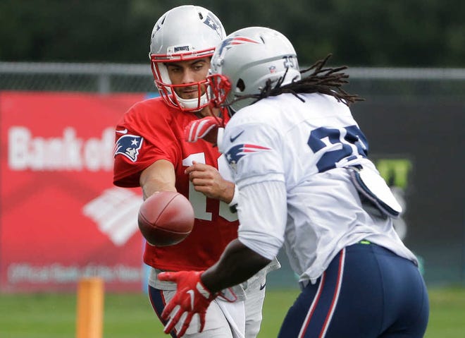 New England Patriots quarterback Jimmy Garoppolo, left, hands off to LeGarrette Blount during practice on Wednesday in Foxborough, Mass. The Patriots play the Arizona Cardinals tonight.