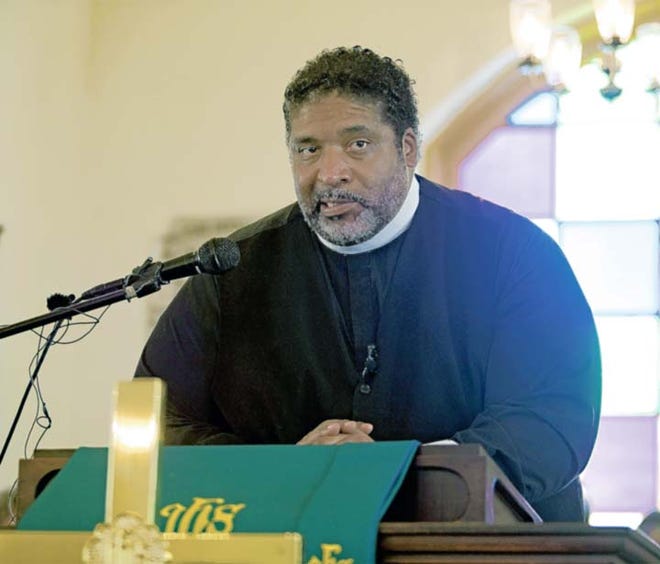 The Rev. William Barber, president of the North Carolina NAACP, rallies a full house at Ebenezper Presbyterian Church in New Bern on Saturday afternoon.