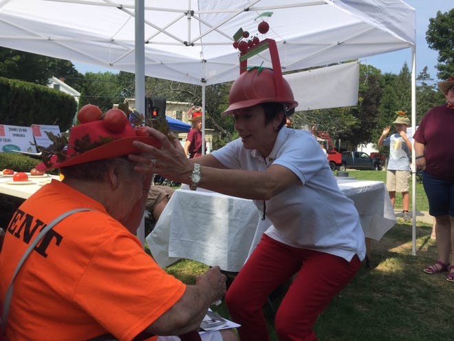Linda Colangelo, right, of Putnam, puts a tomato hat on Glenna Bruno, of Killingly, Saturday at Killingly's Great Tomato Festival.

Joe Groga /The Bulletin