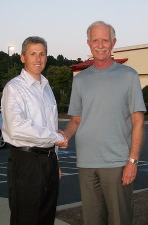 Gastonia native and current Dallas resident Michael Whitesides, left, shakes hands with Capt. Chesley "Sully" Sullenberger in 2009. This photo was taken six months after the 'Miracle on the Hudson' plane crash, when the two met for coffee at a Starbucks in Charlotte. (Contributed photo)