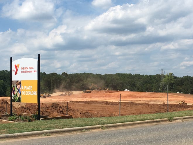 Heavy construction vehicles have been working on landscaping at the future site of the YMCA at Robinwood Lake in Gastonia, though they have thus far stayed out of the floodplain. MICHAEL BARRETT/THE GAZETTE