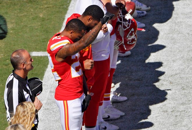 Kansas City Chiefs cornerback Marcus Peters raises his fist in the air during the national anthem before an NFL football game against the San Diego Chargers on Sunday, Sept. 11, 2016, in Kansas City, Mo. (John Sleezer/The Kansas City Star via AP)