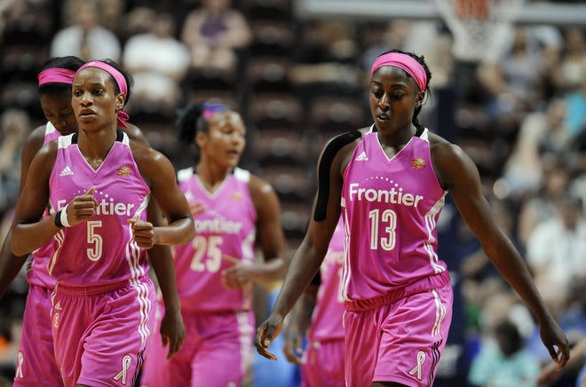 Connecticut's Jasmine Thomas, left, and Chiney Ogwumike walk off the court Sunday during a timeout in the Sky's 96-86 win over the Sun at Mohegan Sun Arena. ASSOCIATED PRESS PHOTOS