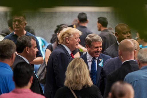 Republican Presidential Candidate Donald Trump, center, speaks with Rep. Michael McCaul, R-Texas, right, as he attends a ceremony at the National September 11 Memorial, in New York, Sunday, Sept. 11, 2016, on the 15th anniversary of the Sept. 11 attacks.