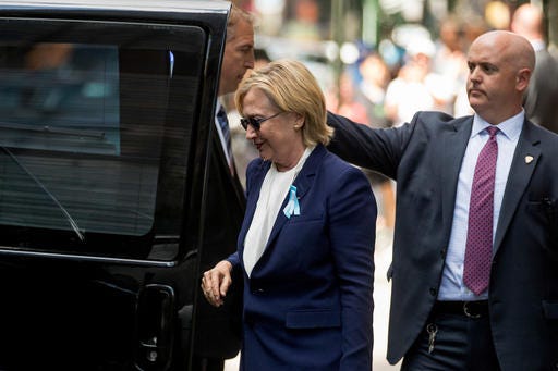 Democratic presidential candidate Hillary Clinton gets into a van as she leaves an apartment building Sunday, Sept. 11, 2016, in New York. Clinton's campaign said the Democratic presidential nominee left the 9/11 anniversary ceremony in New York early after feeling "overheated."