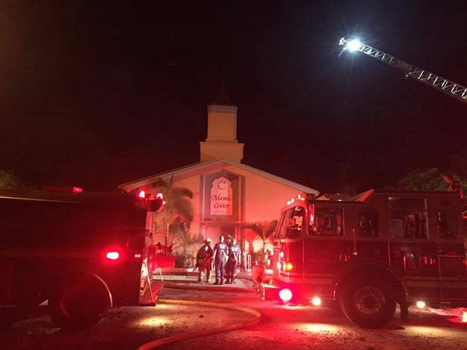 In this photo provided by the St. Lucie Sheriff's Office, firefighters work at the scene of a fire at the Islamic Center of Fort Pierce on Monday, Sept. 12, 2016, in Fort Pierce, Fla. (St. Lucie Sheriff's Office via AP)