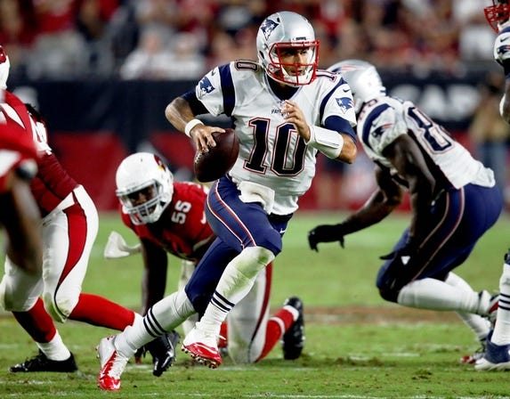 New England Patriots quarterback Jimmy Garoppolo scrambles against the Arizona Cardinals during Sunday night's opening game. Garappolo threw for 264 yards and one touchdown with no interceptions, leading the Pats to a 23-21 victory. AP Photo/Ross D. Franklin