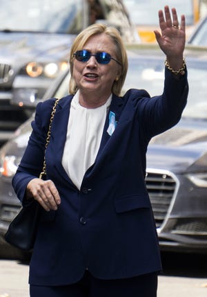 Democratic presidential candidate Hillary Clinton walks from her daughter's apartment building Sunday in New York. Clinton unexpectedly left Sunday's 9/11 anniversary ceremony in New York after feeling "overheated," according to her campaign, which later revealed she had been diagnosed with pneumonia. AP Photo/Craig Ruttle
