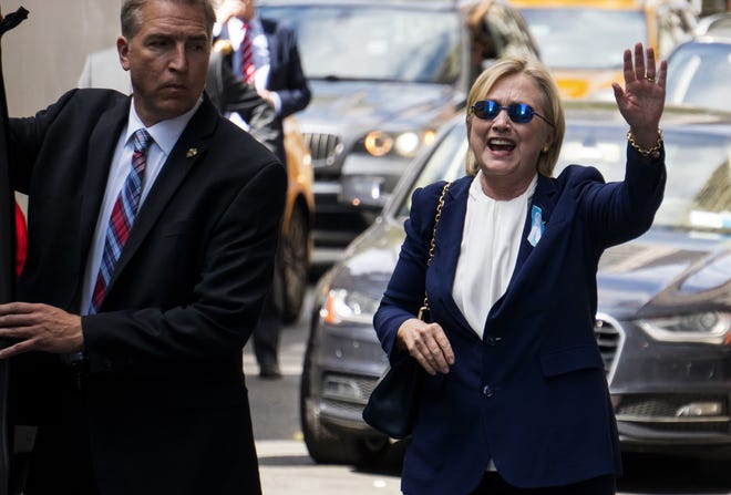 Democratic presidential candidate Hillary Clinton waves as she walks from her daughter's apartment building Sunday, Sept. 11, 2016, in New York. Clinton unexpectedly left Sunday's 9/11 anniversary ceremony in New York after feeling "overheated," according to her campaign. (AP Photo/Craig Ruttle)