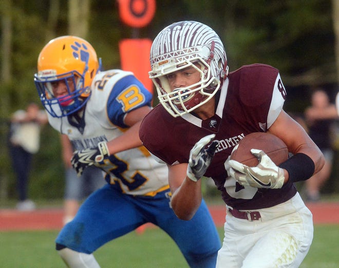 Killingly’s Zack Burgess gets past Bacon Academy’s Jon-Mike Murray Friday on his touchdown run during their game in Killingly. Killingly is tied with New London for the top spot in The Bulletin’s power rankings after Week 1. John Shishmanian/ NorwichBulletin.com