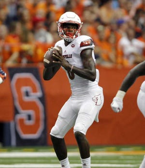Nick Lisi Associated Press Louisville's Lamar Jackson looks to pass the ball in the first half against Syracuse in Syracuse, N.Y., on Friday. The Cardinals won 62-28.