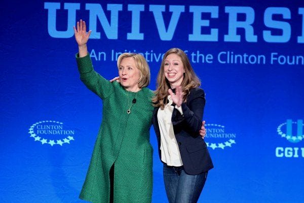 Former Secretary of State Hillary Rodham Clinton and Chelsea Clinton greet the audience Saturday at a conference sponsored by their Clinton Global Initiative at the University of Miami.