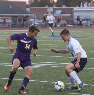 Greencastle-Antrim's Luke Herman (right) tries to control the ball around Boiling Springs' Kevin Barnes during Tuesday's boys' varsity soccer game at Kaley Field.