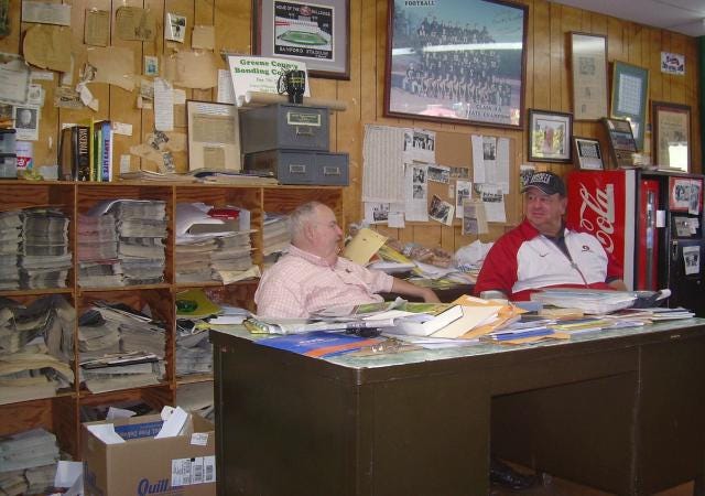 The Herald-Journal owner Carey Williams, left, speaks to a visitor to his newsroom a few years back. Williams hit the jack pot on Saturday.