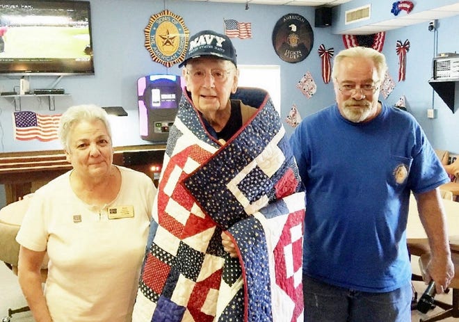Pictured, from left, are Quilts of Valor Foundation Florida State Coordinator Pam Leese, World War II Navy Veteran Robert J. Martin and American Legion Post 120 Commander George Howard.