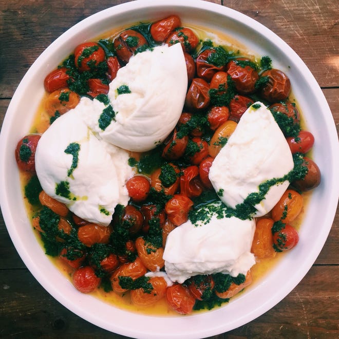 Flavor pops out from the inside of both cherry tomatoes and balls of burrata cheese. (Katie Workman via AP)