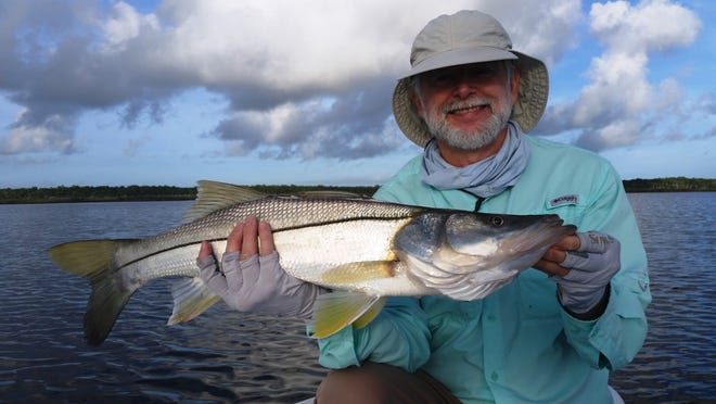 Don Lampton from Kentucky shows off a 29-inch snook he caught in the Matanzas River on a top-water plug in Flagler Beach earlier this week. PALMCOASTFISHING.COM/CAPT. CHRIS HERRERA