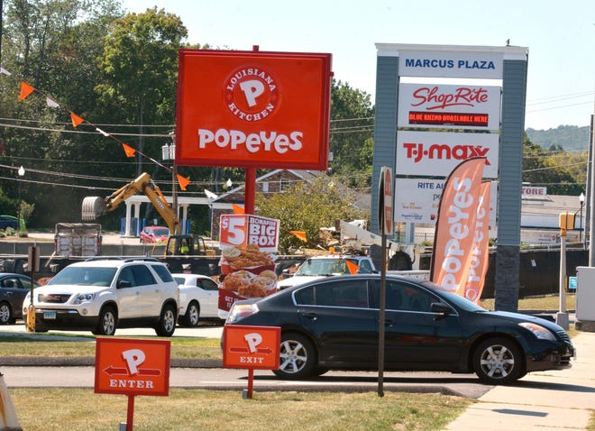 A car leaves Popeye's Louisiana Kitchen Wednesday afternoon as construction for a building that will soon house a Moe's Southwest Grill and Verizon retail store is fenced off at Marcus Plaza along West Main Street in Norwich.

Aaron Flaum/ NorwichBulletin.com