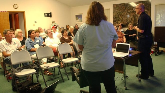 Capt. Josh Portie of the Austin Fire Department, right, and Sherry Kuhl, Austin Water Wildland Conservation division manager, address a meeting of the Lost Creek Civic Organization on Aug. 4.