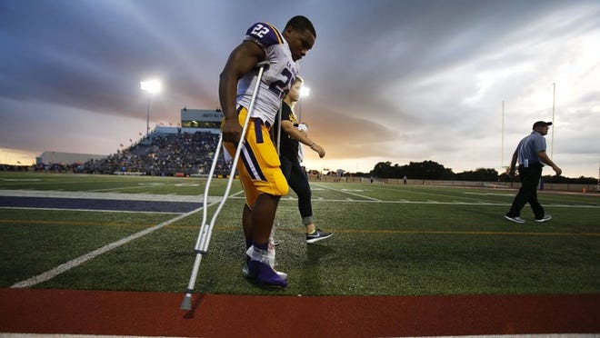 La Grange running back JK Dobbins exits the field at Panther Stadium on crutches after injuring his ankle against Liberty Hill on Friday night. The game between the two Class 4A squads was called off after a series of lightning delays. (Stephen Spillman/For American-Statesman)
