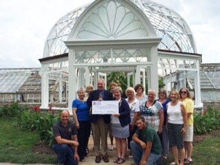 Sonnenberg Executive Director Dave Hutchings, center left with Daughters of the American Revolution member Glena Larson, stands with supporters before the Sonnenberg Palm House conservatory that received $10,000 for restoration from the DAR. PHOTO PROVIDED/ DAR