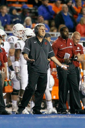 FILE - In this Saturday, Sept. 10, 2016, file photo, Washington State head coach Mike Leach reacts during the second half of an NCAA college football game against Boise State in Boise, Idaho. On Thursday, Sept. 15, 2016, WSU's president and athletic director met with the Pullman, Washington, police chief after Leach suggested his players were being unfairly targeted by law enforcement. (AP Photo/Otto Kitsinger, File)