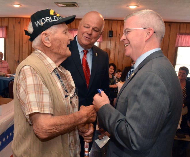 Department of Veterans Affairs Commissioner Sean Connolly pins a Wartime Service Medal onto World War II Army veteran Albert Lockwood from Griswold as State Rep. Paul Brycki looks on at the VFW Post 10004 in Jewett City Thursday afternoon.

Aaron Flaum/ NorwichBulletin.com