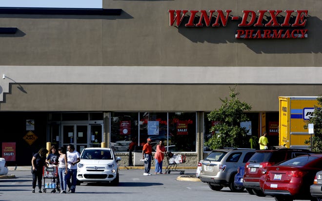 Shoppers leave the Winn-Dixie on North Main Street last Thursday. The company plans to close this location in early October, calling it an underperforming store. Matt Stamey/Special to the Guardian