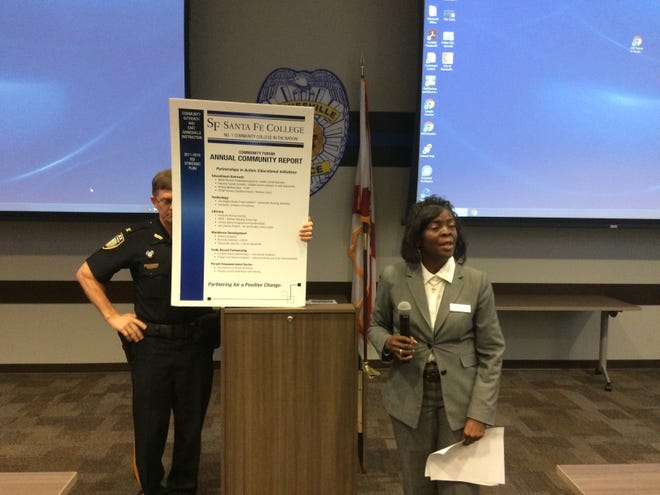 Dr. Karen Cole-Smith, right, director of the Santa Fe College Community Outreach East Gainesville Instruction program, speaks about the program with assistance from Ed Book, chief of the SF College Police Department. Cleveland Tinker/Special to the Guardian