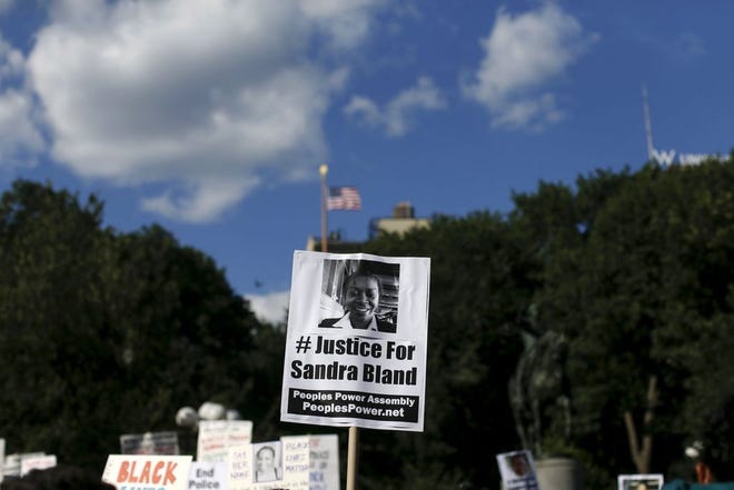 Demonstrators hold signs of Sandra Bland who was found hanged in her Texas jail cell after being taken into custody following a traffic stop, during a rally against police violence in New York, U.S. on July 22, 2015. REUTERS/Shannon Stapleton/File Photo