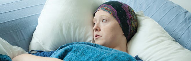 Young girl with cancer in hospital bed